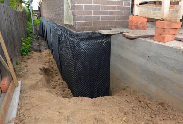 Happy homeowners after waterproofing job in Swain